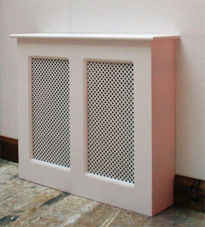 Three-quarter view of a wooden radiator cover with two mesh panels, finished in gloss white