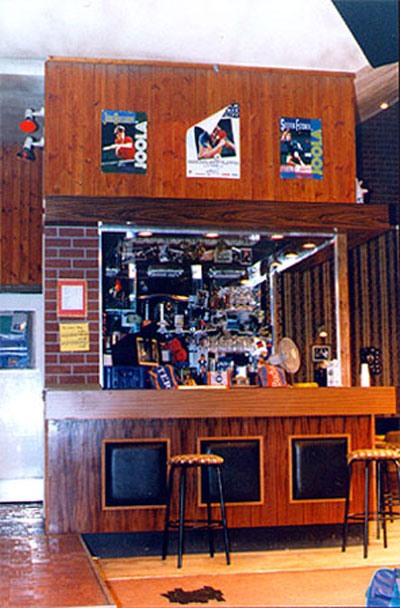 view of stage set - a wood and brick bar with bar-stools, beer pumps and optics behind the counter